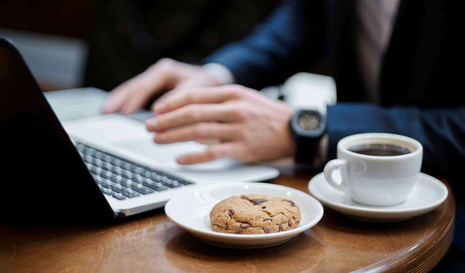 close up of cup of coffee and cookie