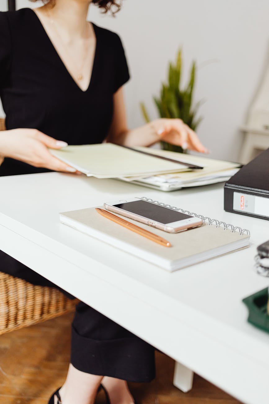 woman sitting at the table with documents