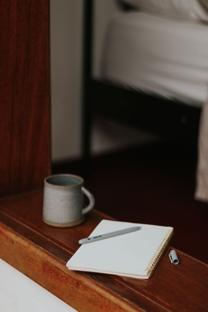 cozy bedroom corner with notebook and mug