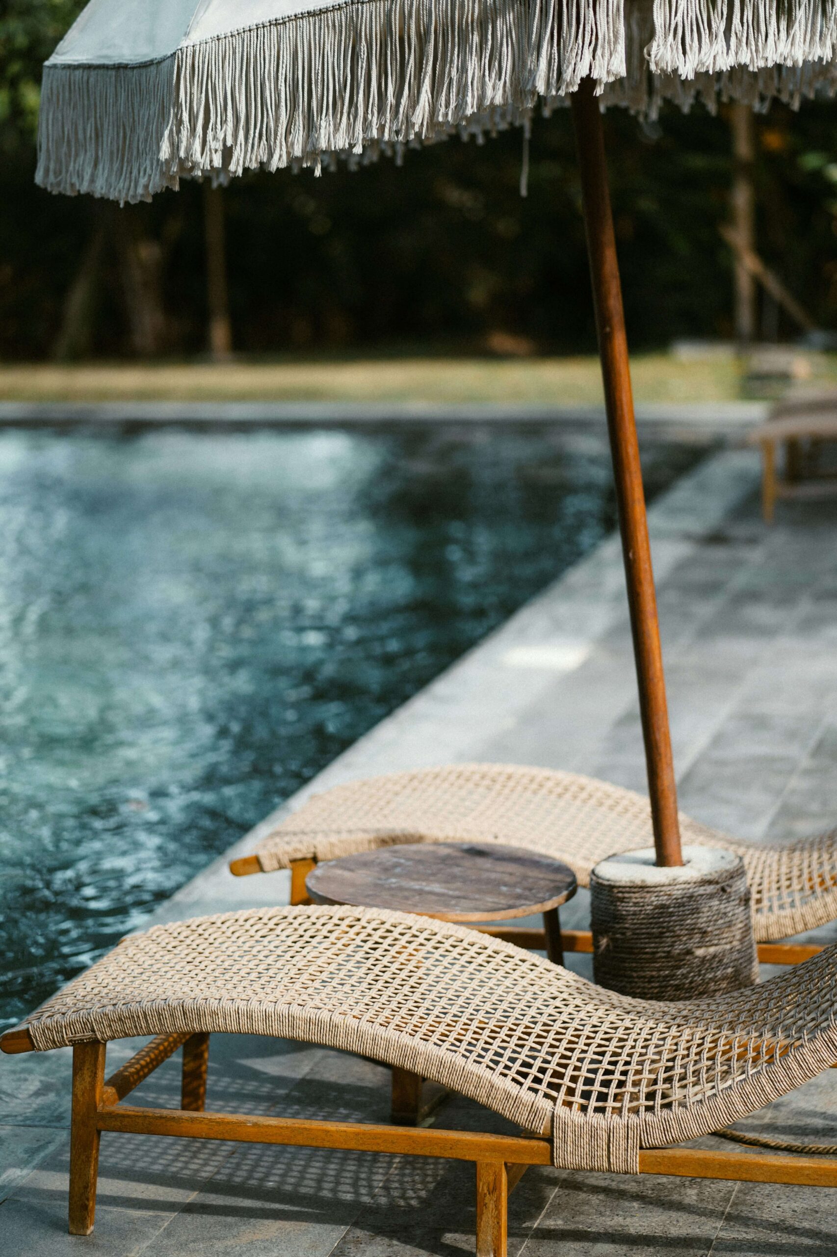 a lounge chair with an umbrella next to a pool - third party administrator 401(k)