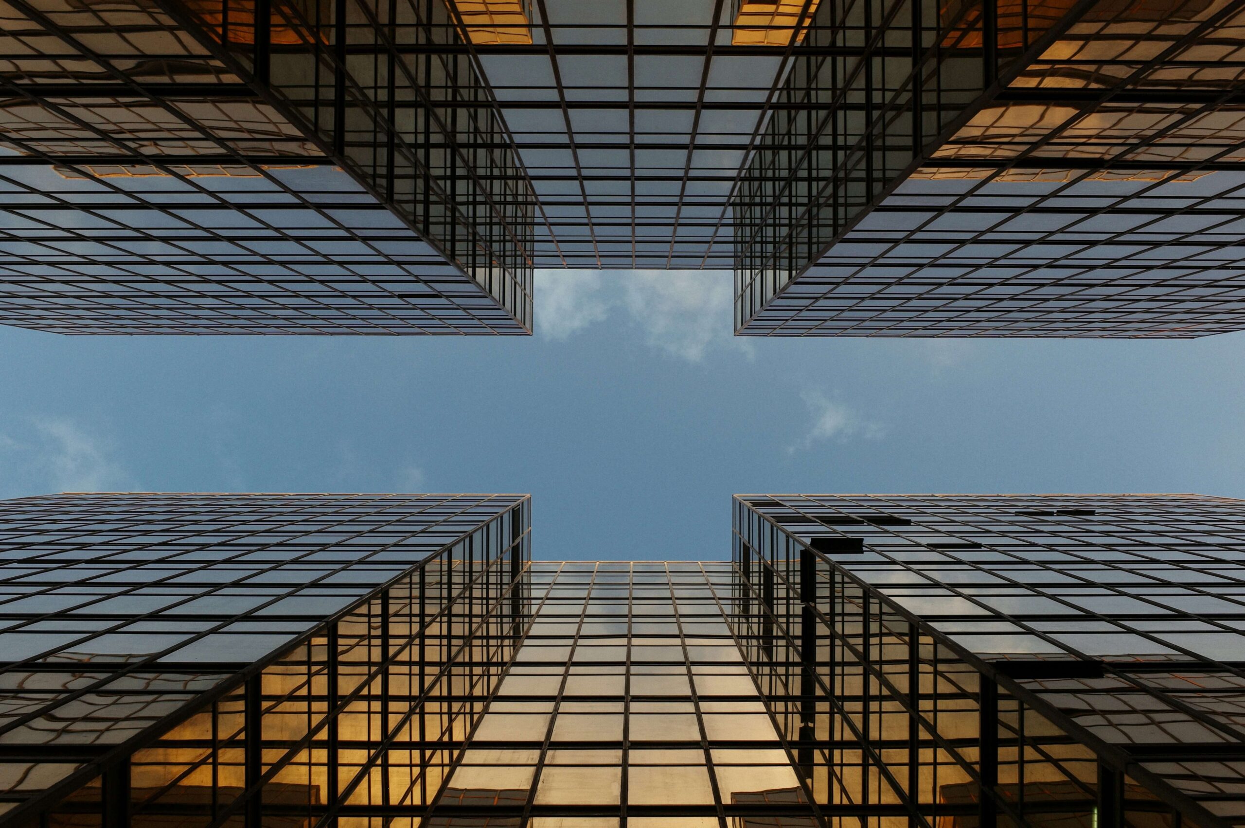 worm view photo of buildings under cloudy sky