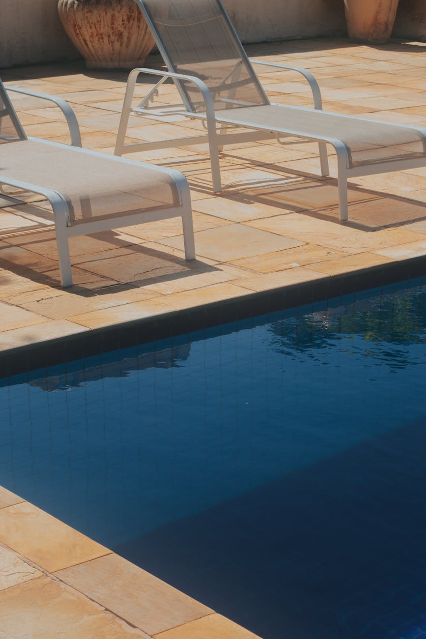 deckchairs by swimming pool