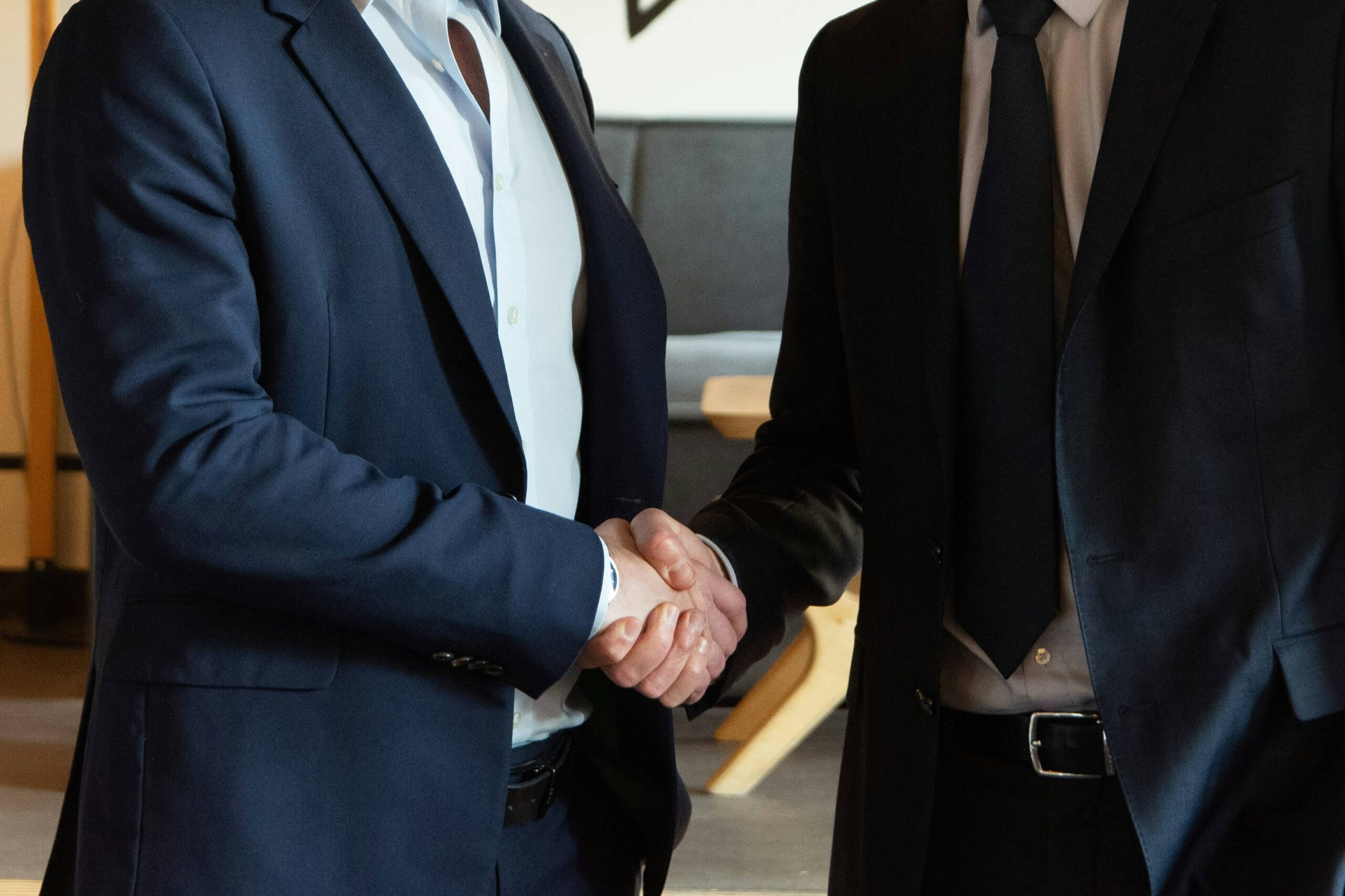 two business partners shaking hands in agreement