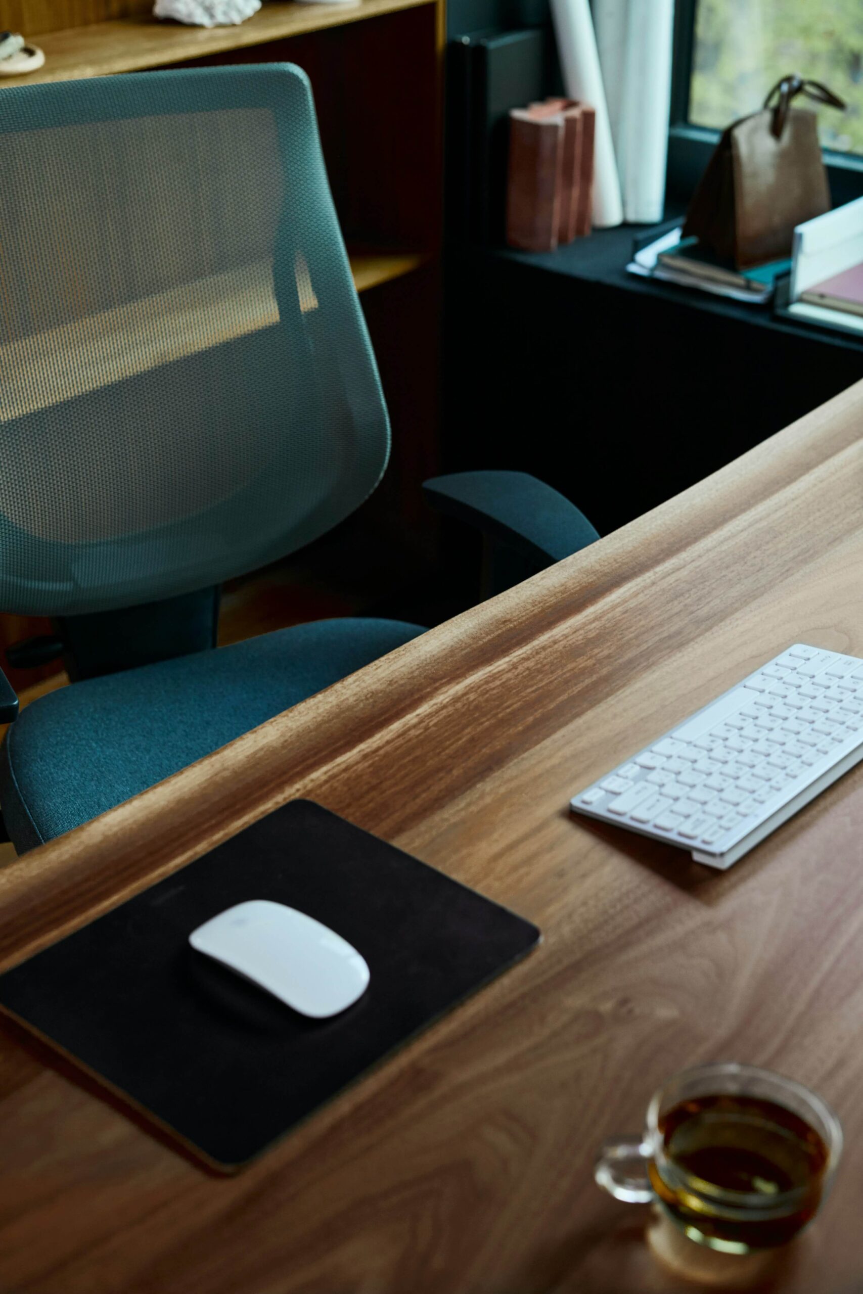 a desk with a computer mouse keyboard and a mouse pad
