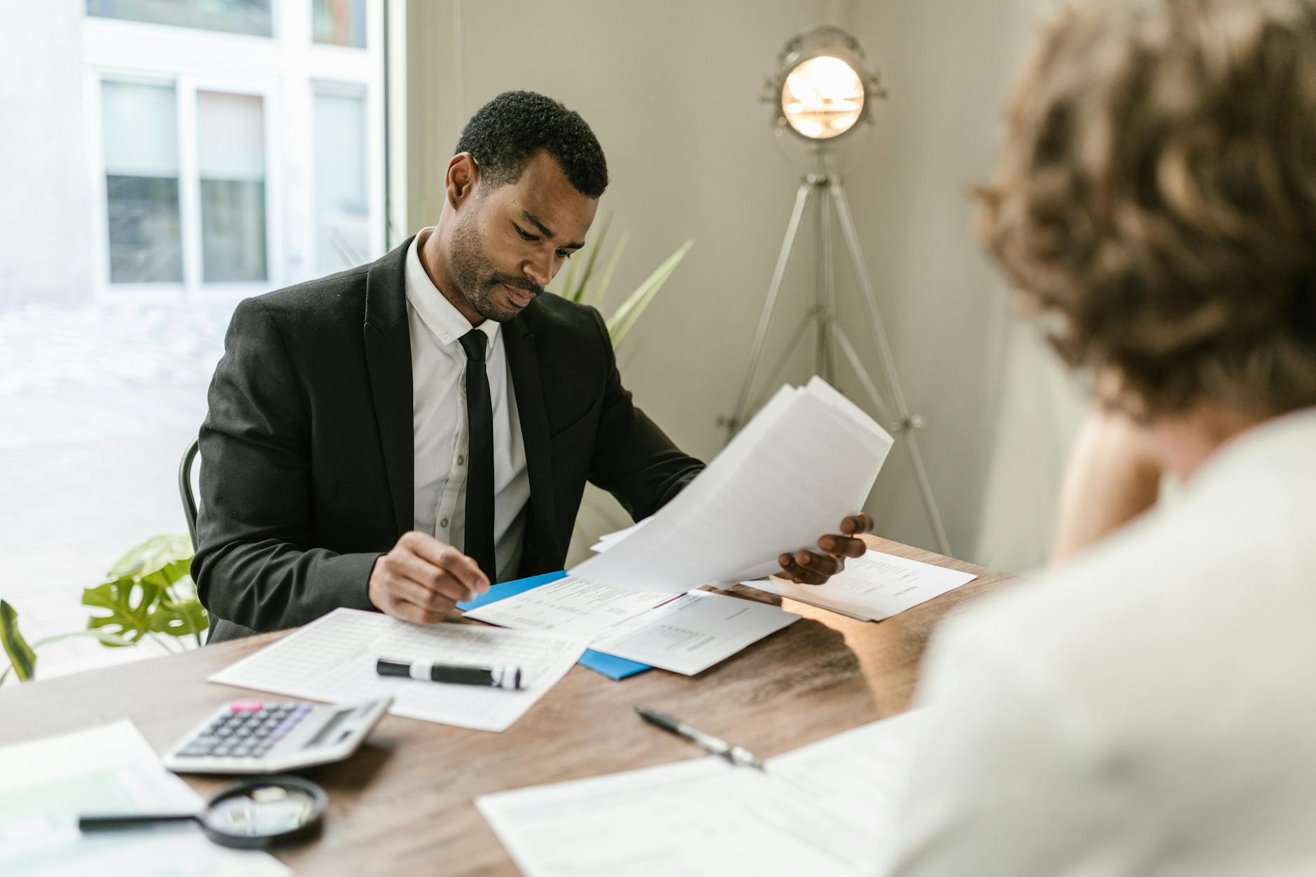 professional man looking at papers - retirement plan notice delivery