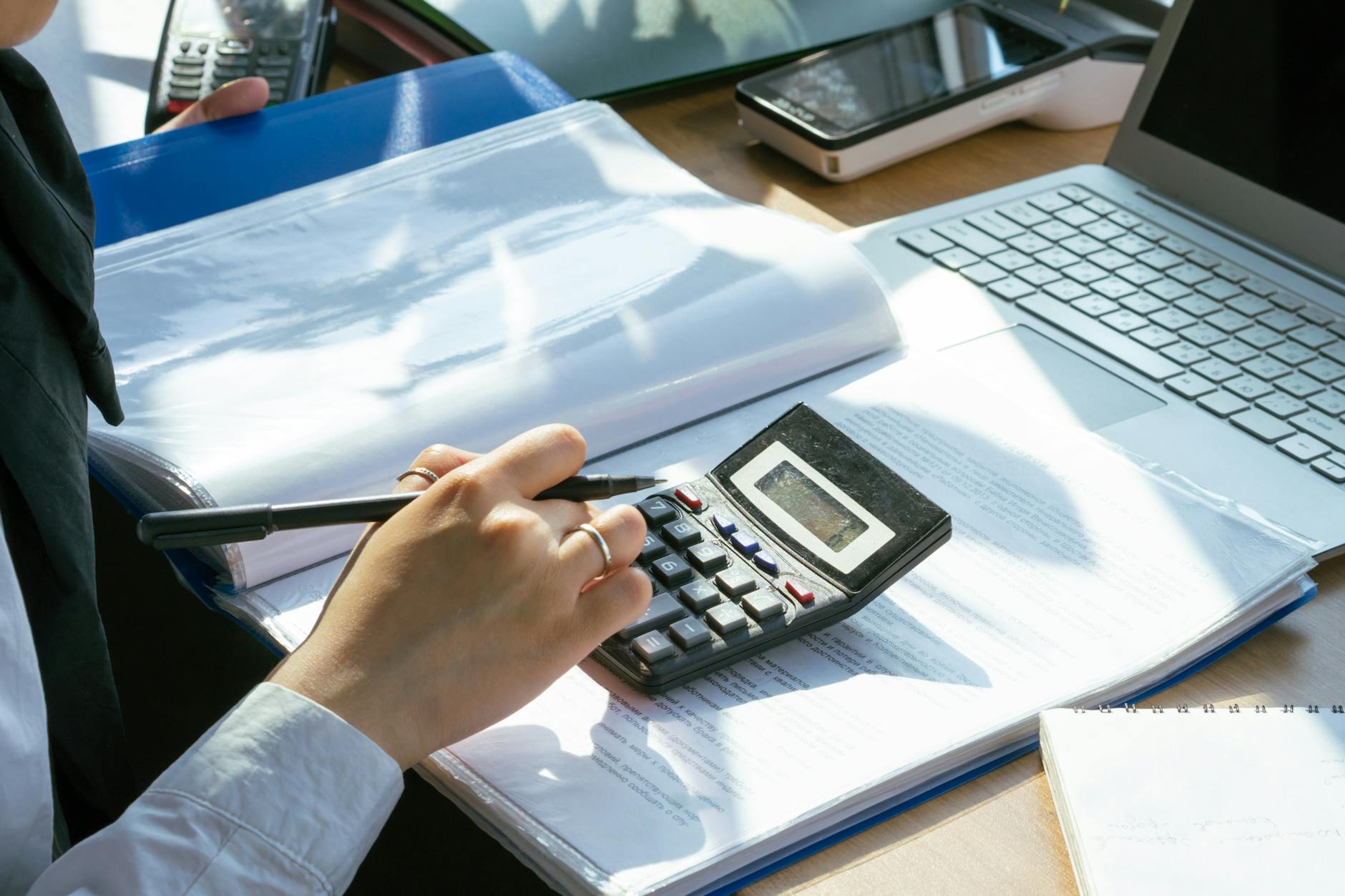 a person using a calculator - accrual-based accounting retirement plan